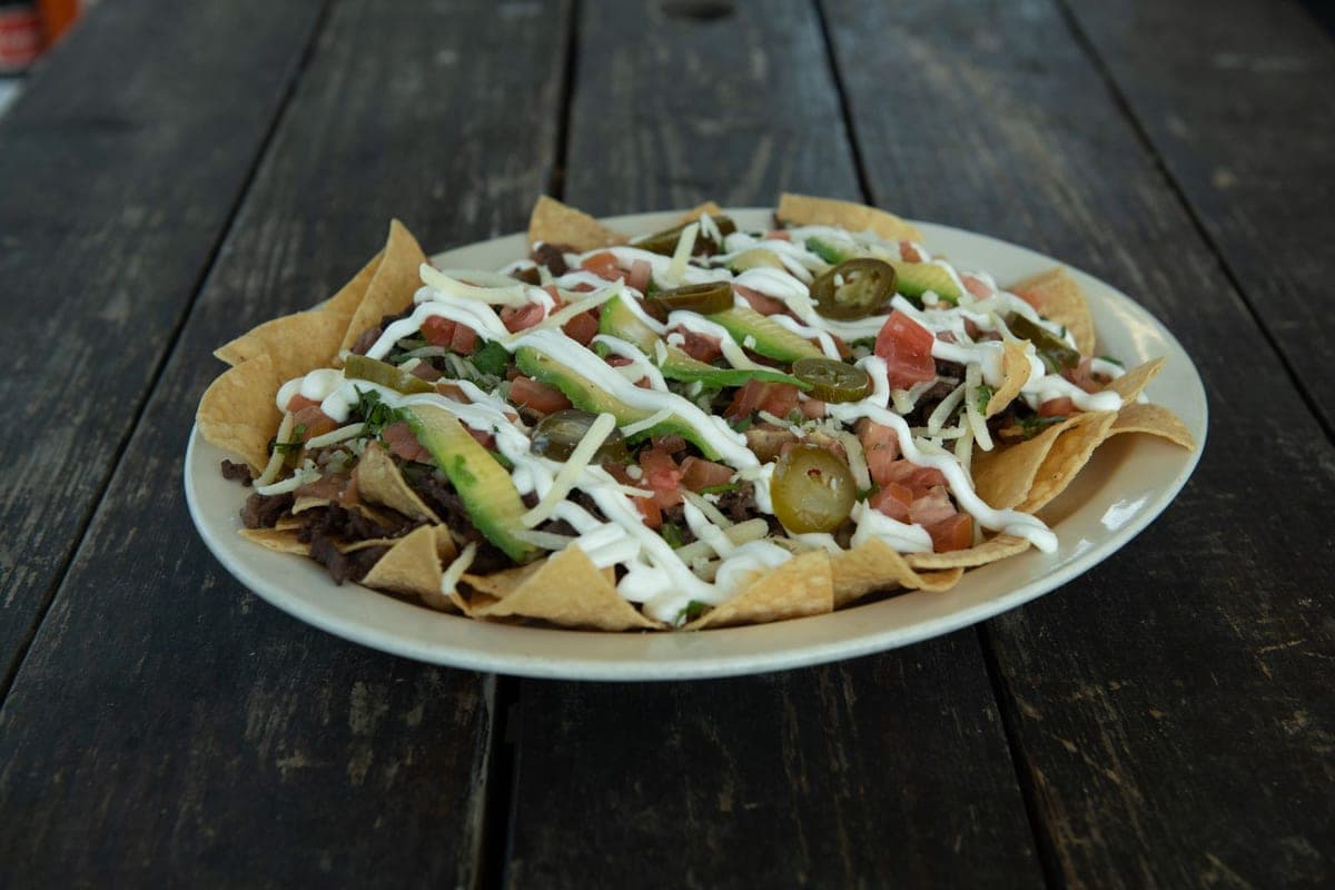 Loaded nachos with seasoned beef, jalapeños and sour cream